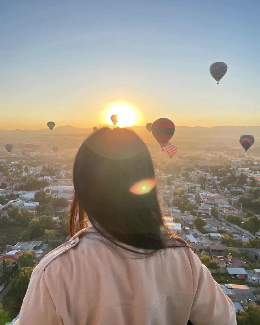 Sunrise with the sun rising over hot air balloons in Teotihuacan