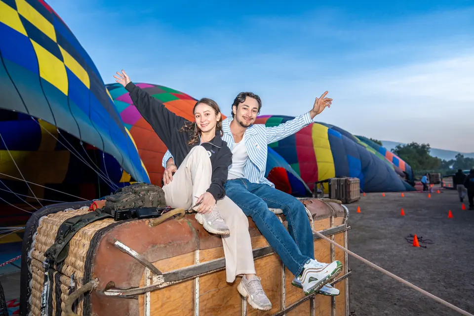 Couple embracing on the basket before their sunrise balloon flight in Teotihuacan