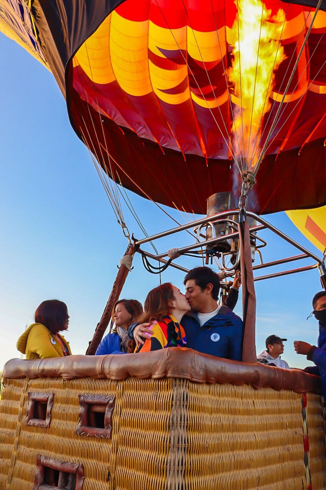 Certified pilot and passengers aboard a red hot air balloon in Teotihuacan